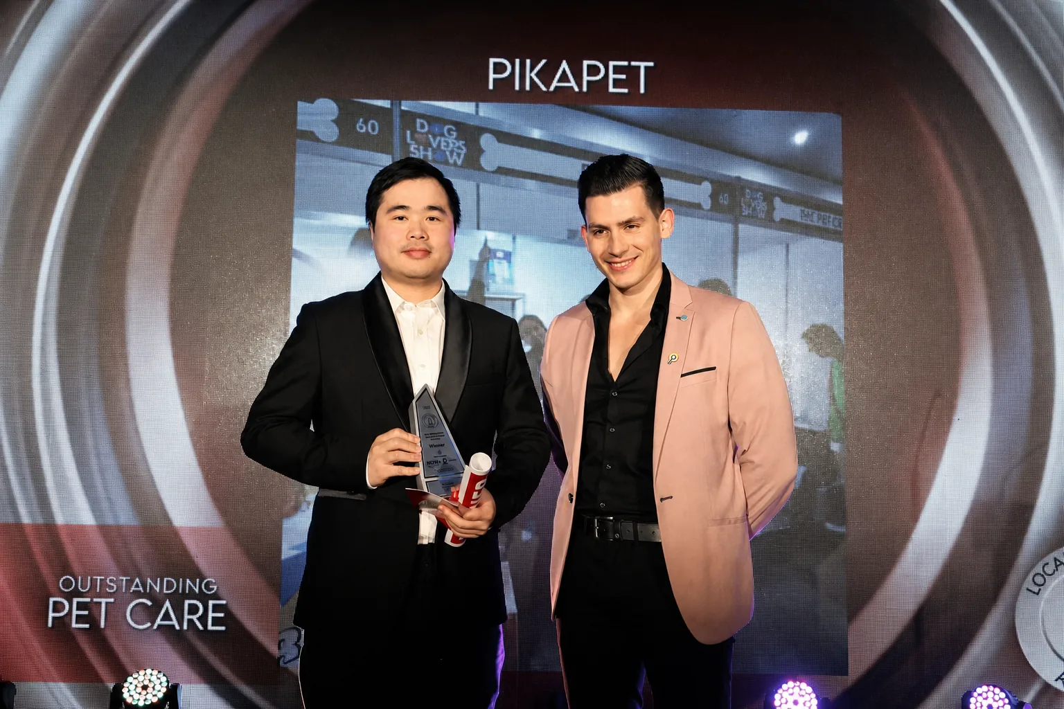 Lance holding PIKAPET's 2024 East Melbourne Local Business Award for Pet Care on the award stage